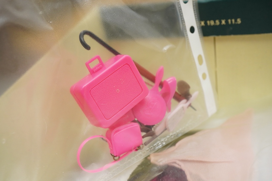 A 1960's Mattel Inc. Barbie doll, 1963, together with a Skipper doll, and a collection of eight original outfits with accessories, sorted into individual packets, outfits purchased between 1963 to 1966 include; American